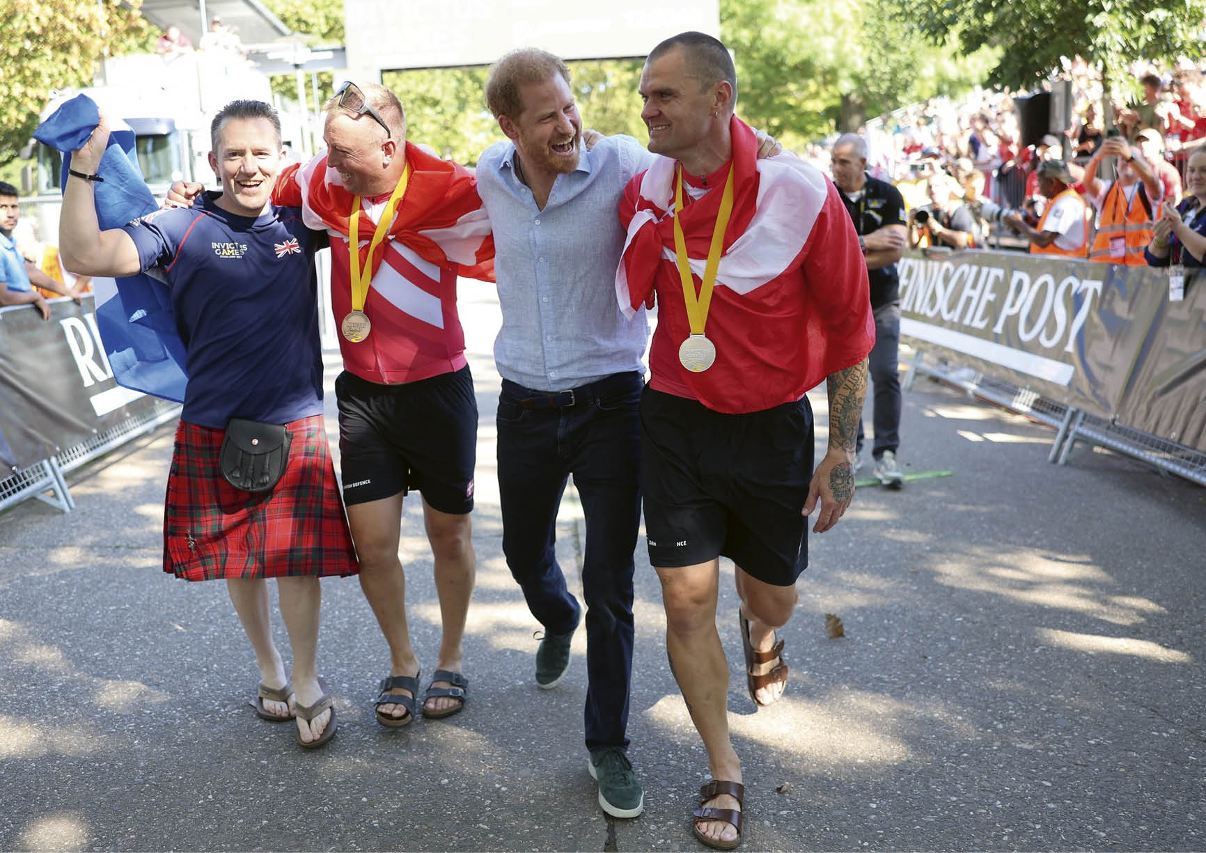 DUESSELDORF, GERMANY - SEPTEMBER 15: Prince Harry, Duke of Sussex rejoices with the winners at the cycling medal ceremony at the Cycling Track during day six of the Invictus Games D sseldorf 2023 on September 15, 2023 in Duesseldorf, Germany. (Photo by Chris Jackson/Getty Images for the Invictus Games Foundation)